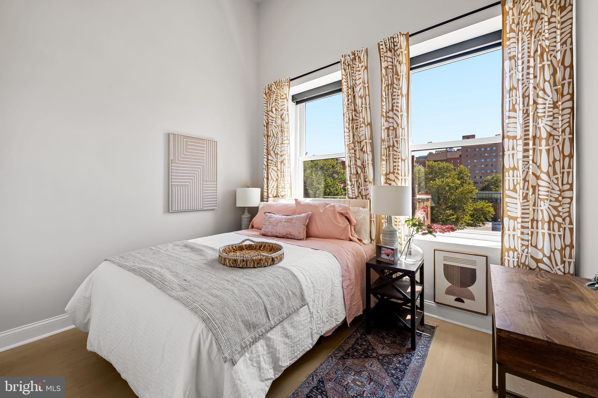 600 North Howard Street, Unit 101 Baltimore, MD 21201 - Photo 2 of 36 a bedroom with a large bed and a large window