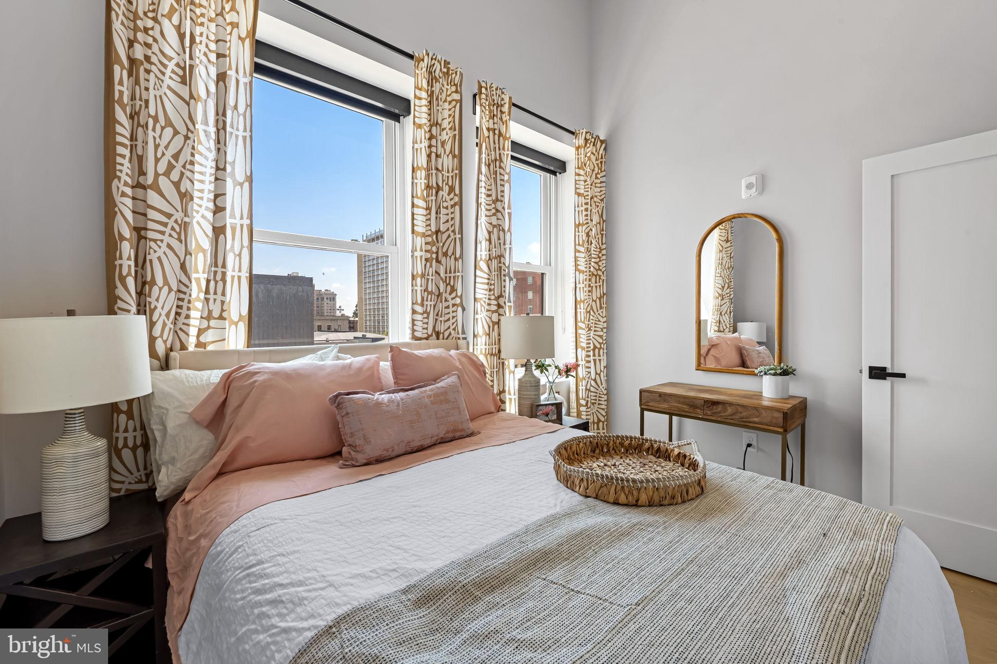 600 North Howard Street, Unit 101 Baltimore, MD 21201 - Photo 24 of 36 a bedroom with a bed and a large window