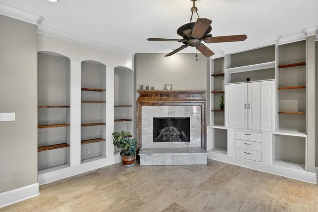 a view of a livingroom with a fireplace and cabinet