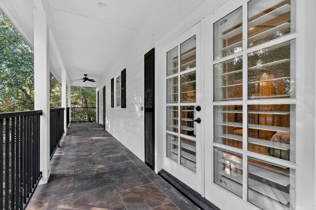 a bedroom with a bed a window and a chandelier