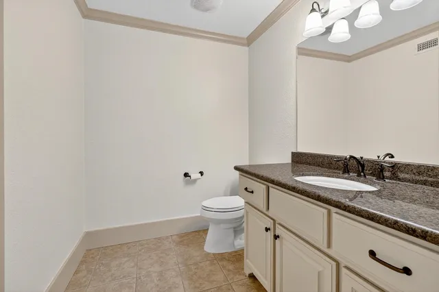 a kitchen with granite countertop a sink stove and cabinets