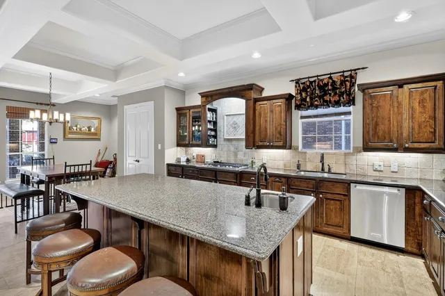 a kitchen with a table chairs sink and stove