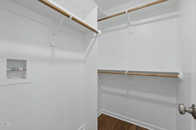 a view of walk in closet with empty racks
