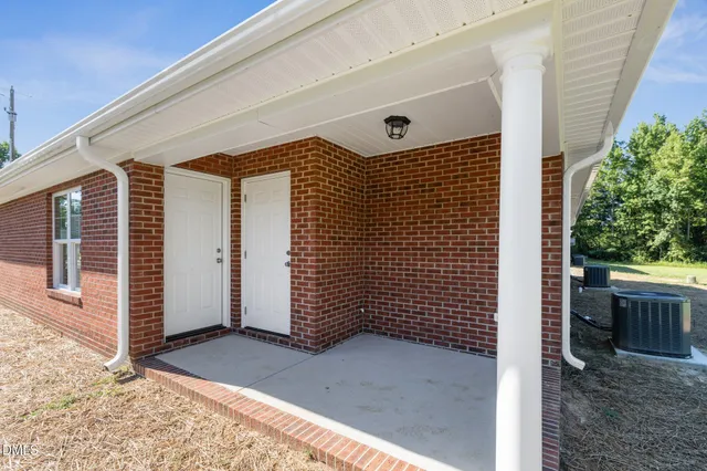 a view of a yard with a house in the background