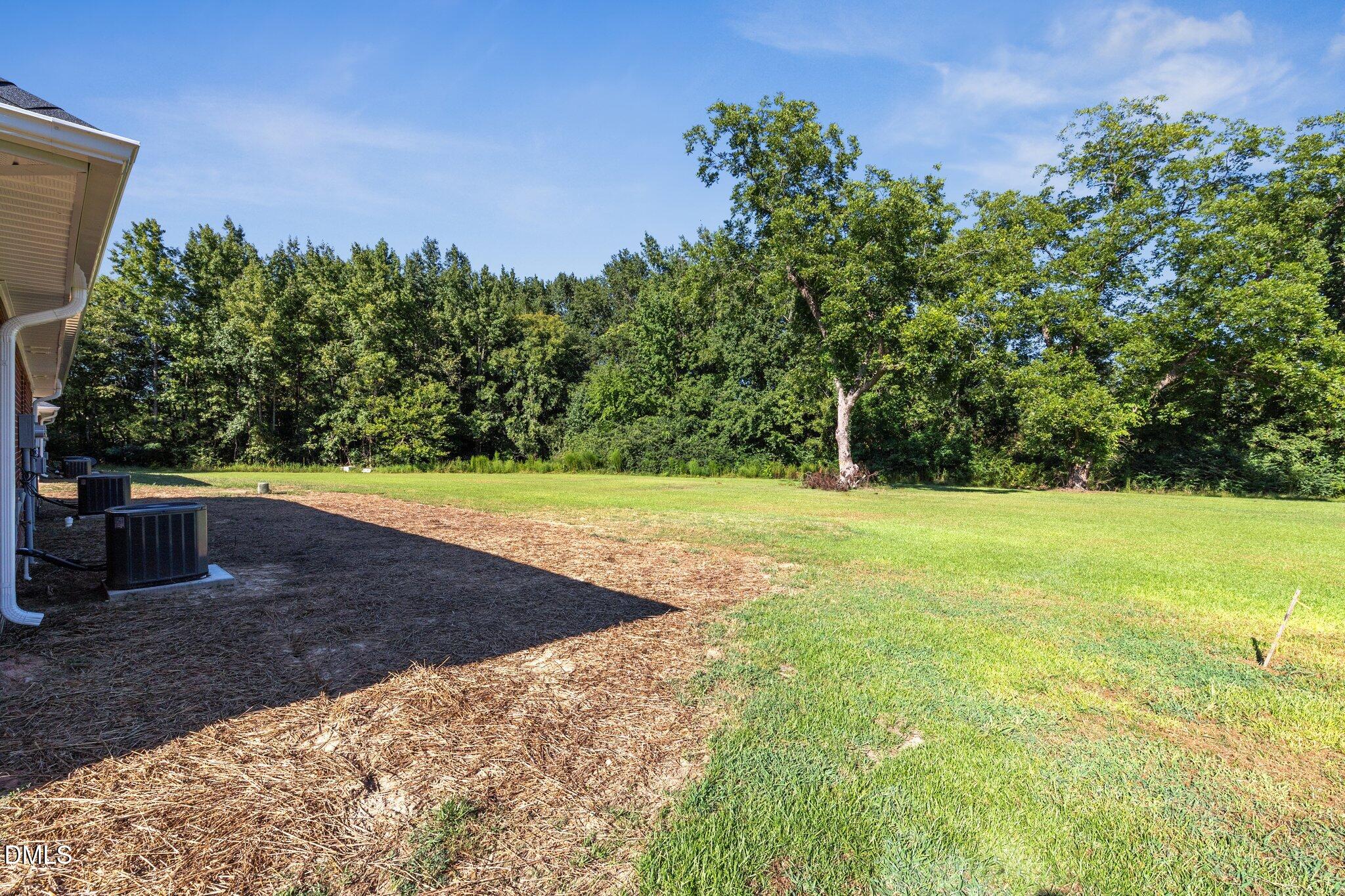 597 Pendergraft Road Bunnlevel, NC 28323 - Photo 19 of 21 a view of a yard with a house in the background