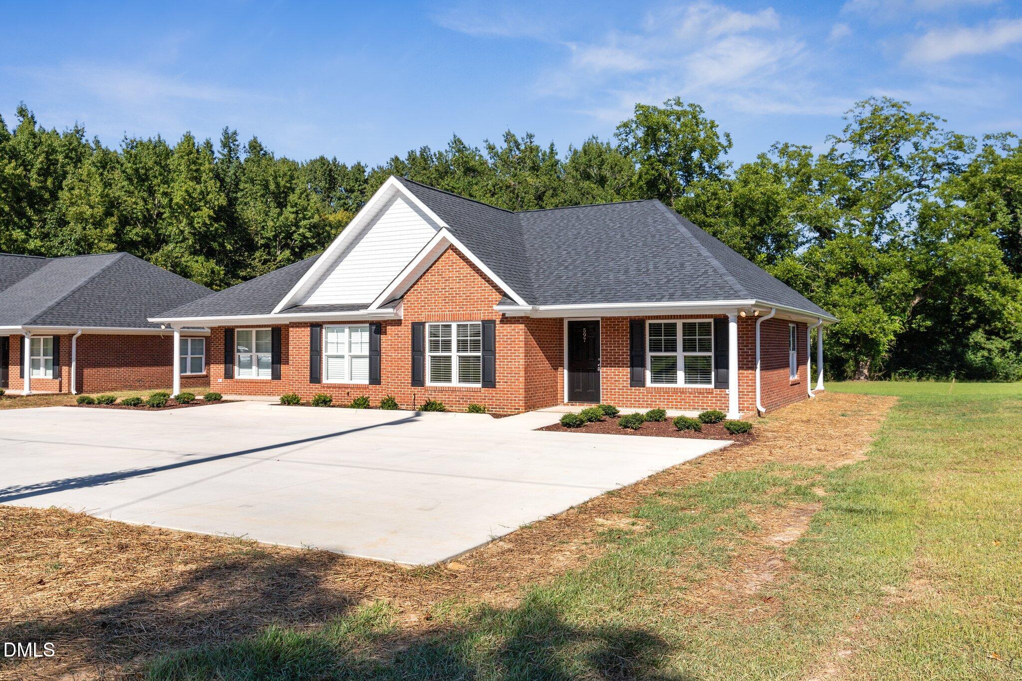 597 Pendergraft Road Bunnlevel, NC 28323 - Photo 2 of 21 a front view of a house with a garden