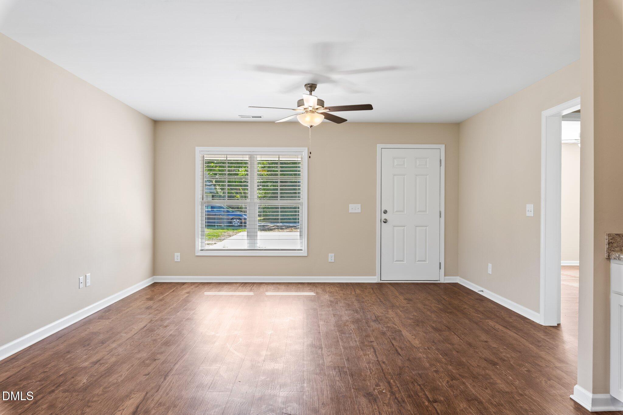 597 Pendergraft Road Bunnlevel, NC 28323 - Photo 7 of 21 a view of an empty room with wooden floor and a window