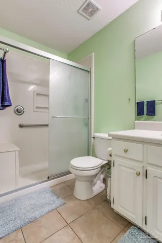a bedroom with furniture and a chandelier fan