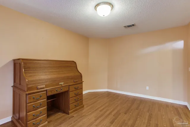 a kitchen with white cabinets and refrigerator