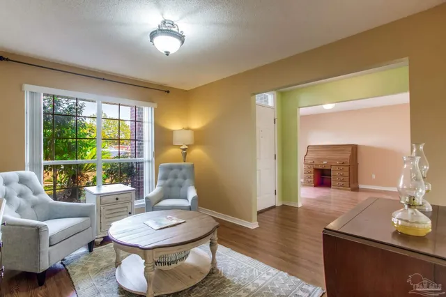 a view of a livingroom with wooden floor and a fireplace