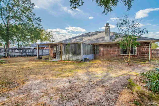 a view of a house with backyard porch and sitting area