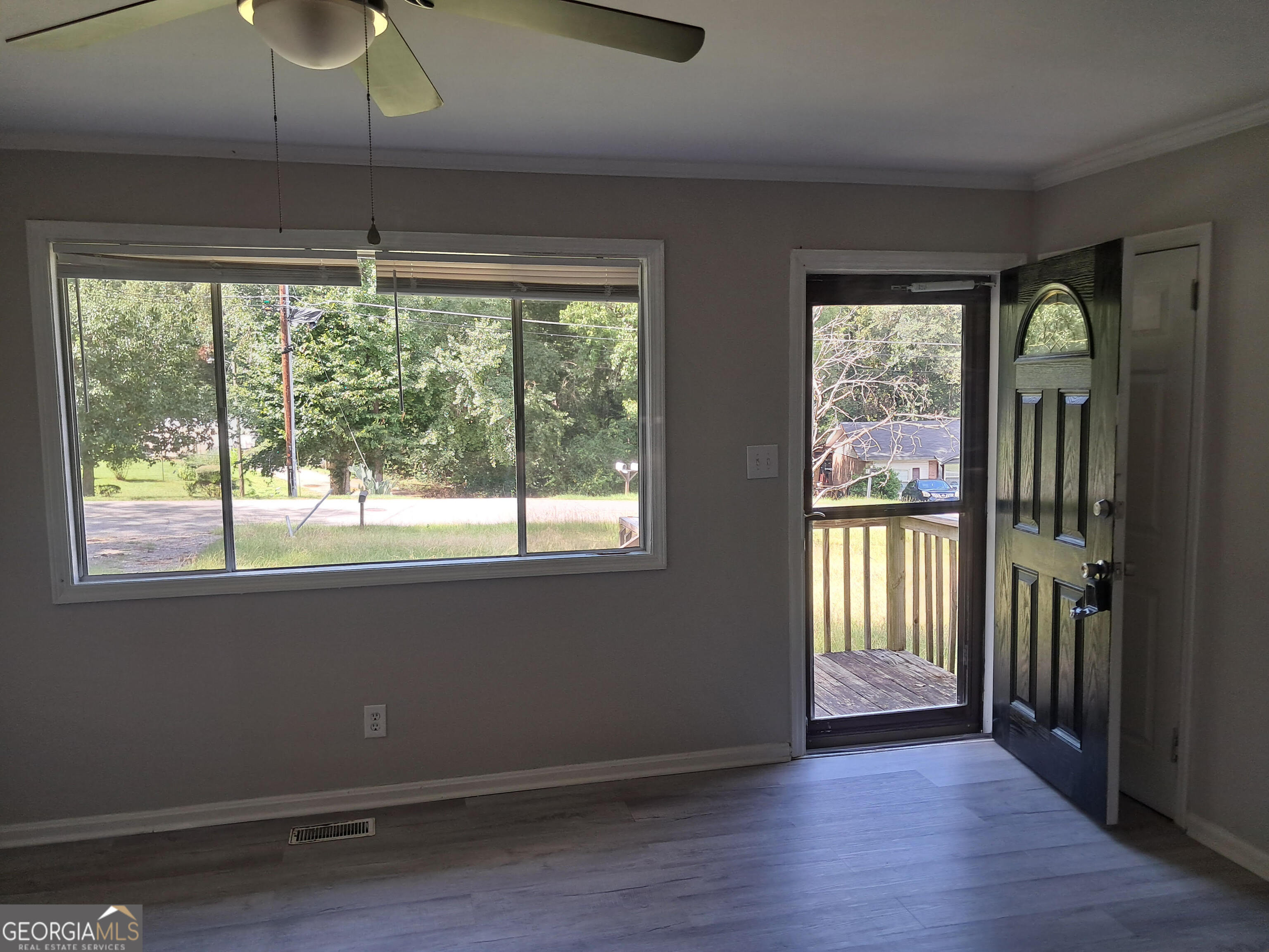 193 Frazier Drive Southeast Milledgeville, GA 31061 - Photo 15 of 38 a view of an empty room with wooden floor and a window