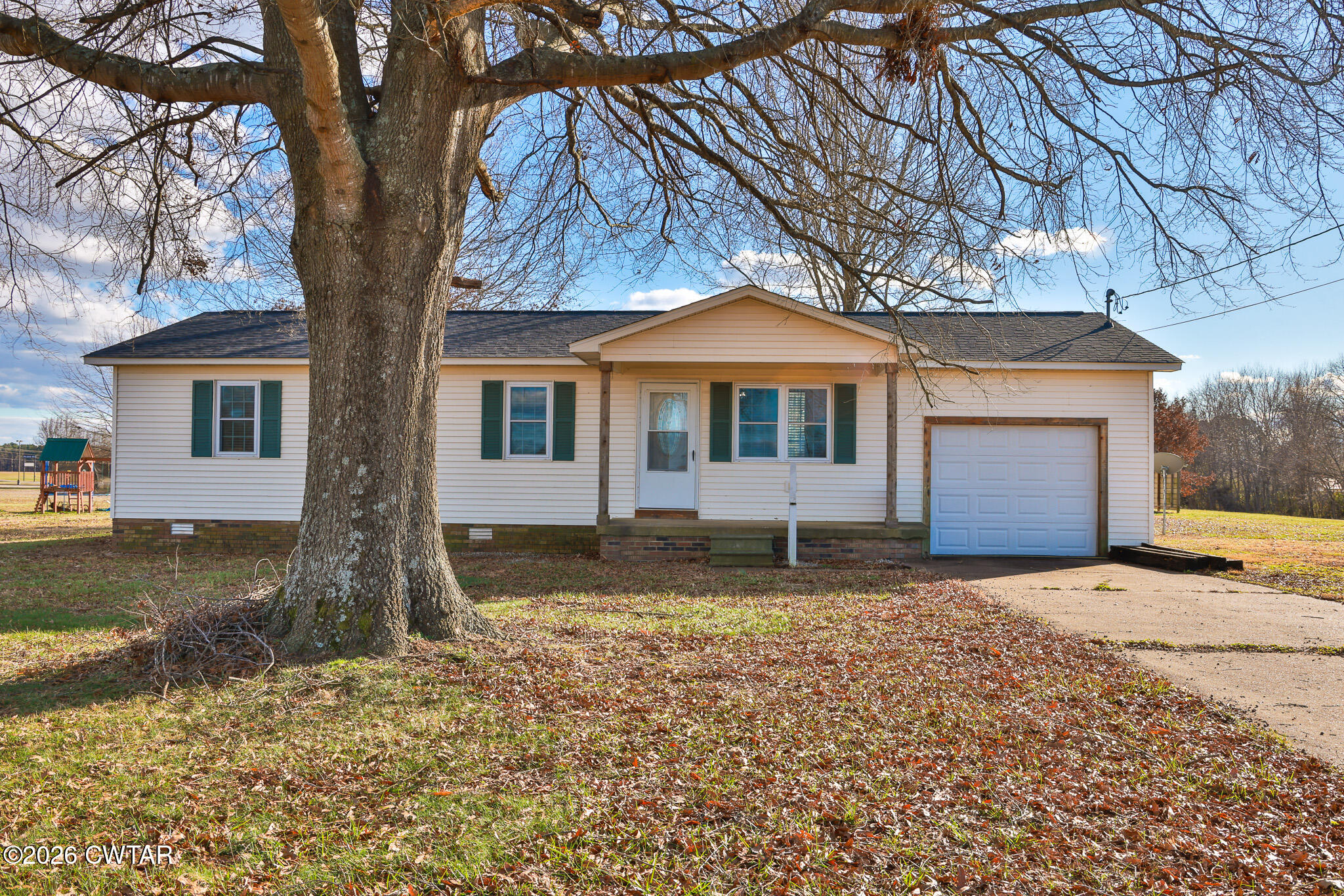 180 Everett Road McKenzie, TN 38201 - Photo 17 of 27 a front view of a house with a yard