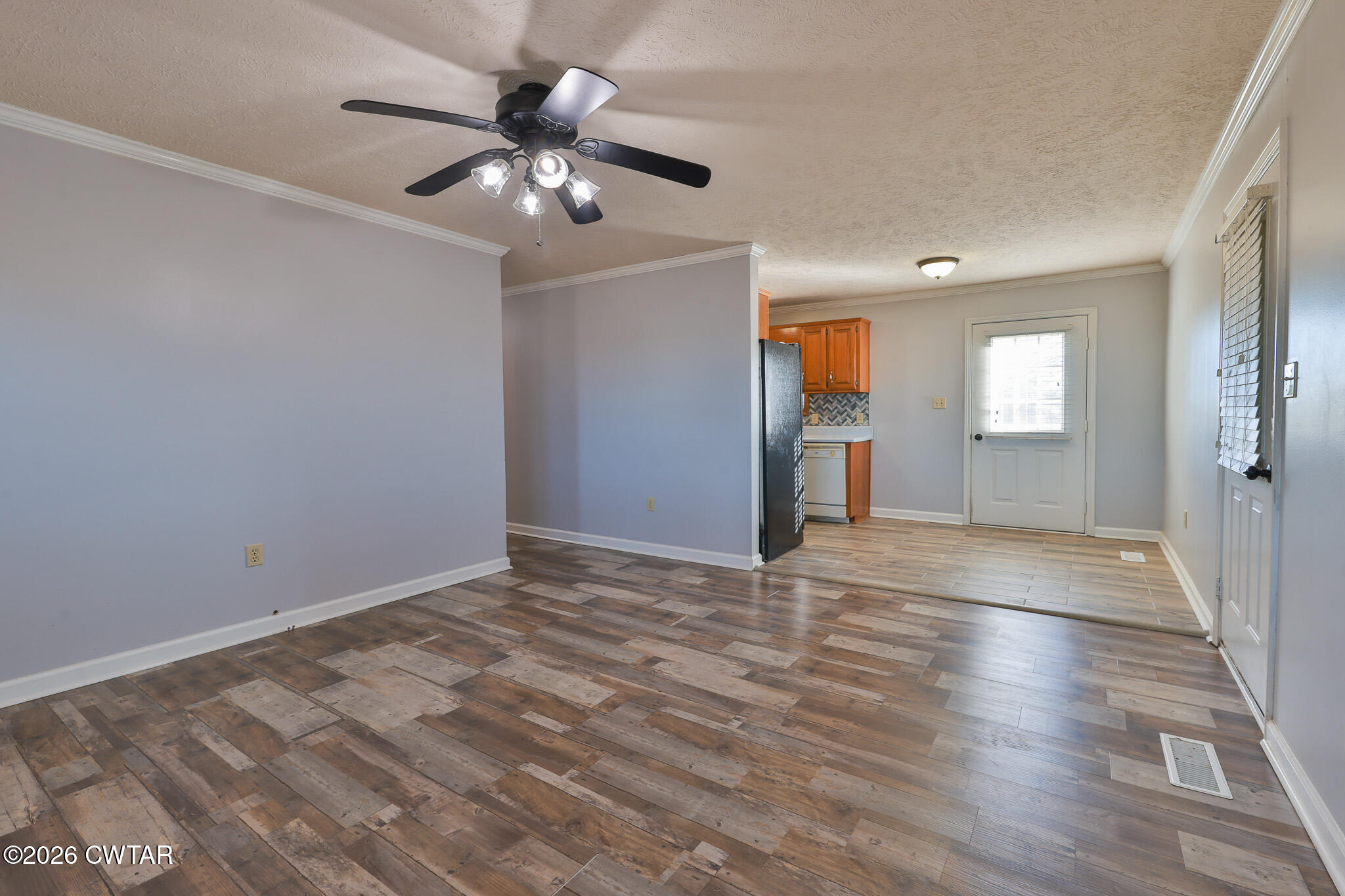 180 Everett Road McKenzie, TN 38201 - Photo 3 of 27 a view of an empty room with wooden floor and a ceiling fan
