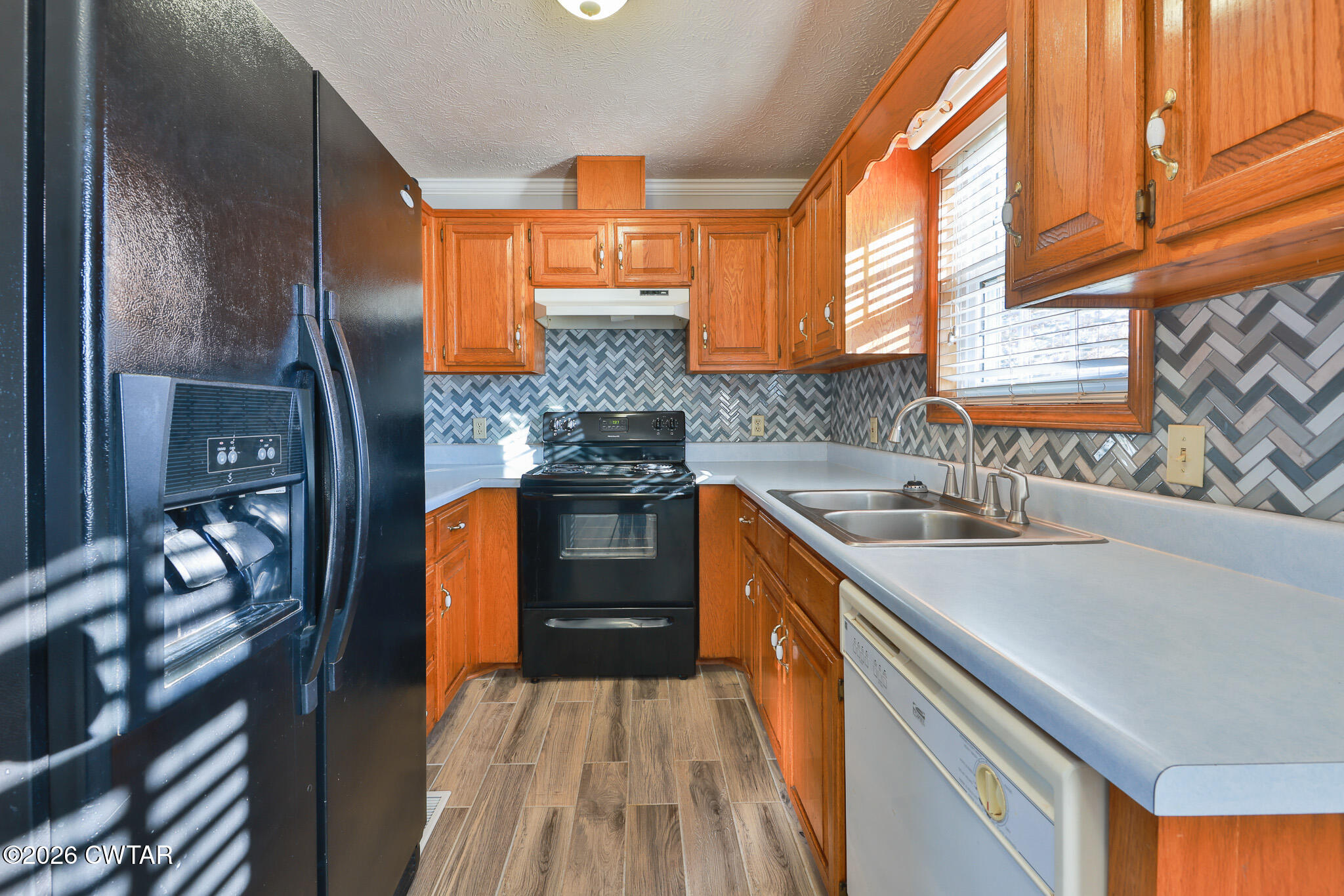 180 Everett Road McKenzie, TN 38201 - Photo 5 of 27 a kitchen with stainless steel appliances granite countertop a sink and a stove