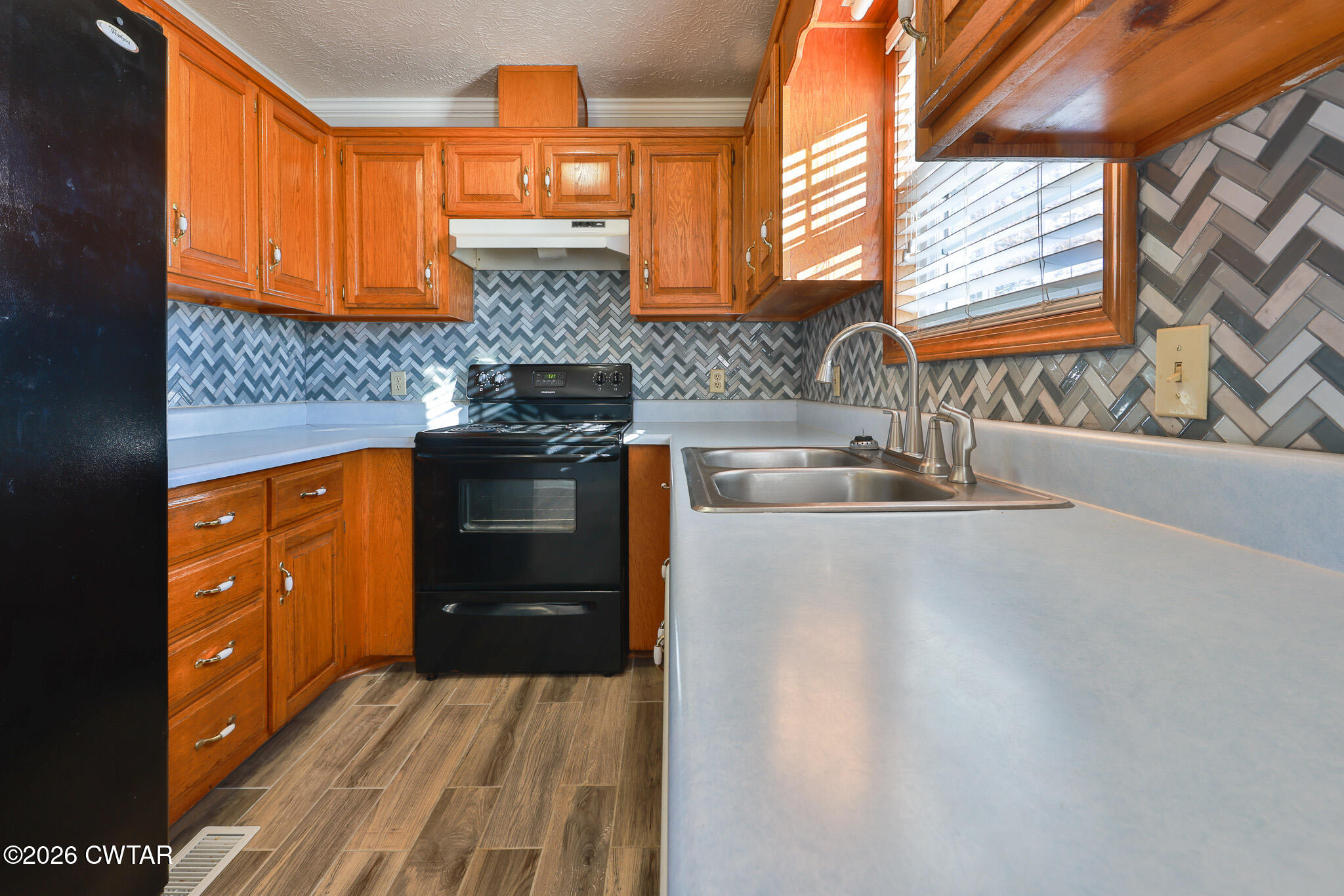 180 Everett Road McKenzie, TN 38201 - Photo 6 of 27 a kitchen with stainless steel appliances a sink stove and cabinets