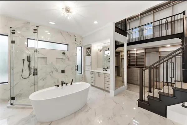 a bathroom with a double vanity sink a toilet a mirror and shower