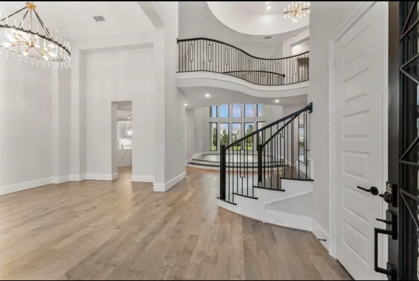 a view of entryway and hall with wooden floor