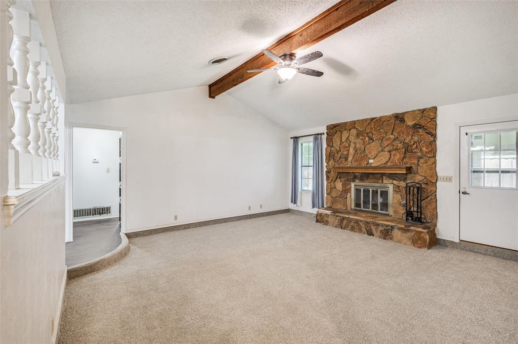 508 South Pedigo Street Pilot Point, TX 76258 - Photo 2 of 26 Living area with vaulted white ceiling and exposed wood beam
