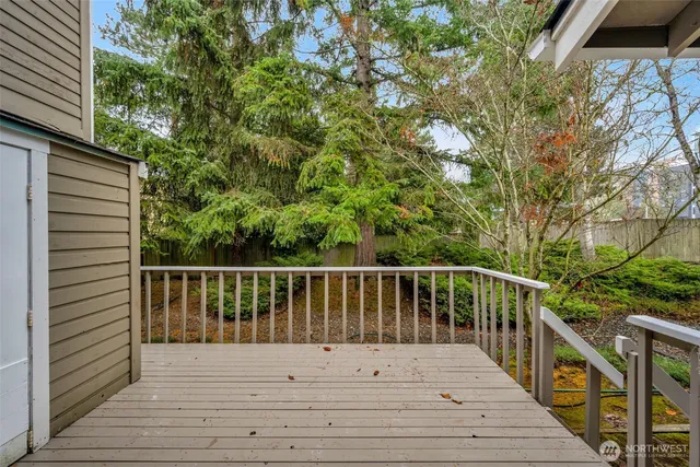 a view of balcony with wooden floor and fence
