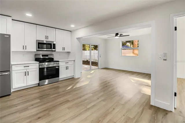 a kitchen with granite countertop a stove and a refrigerator