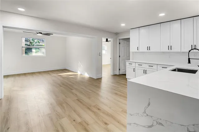 a view of kitchen with wooden floor electronic appliances and window