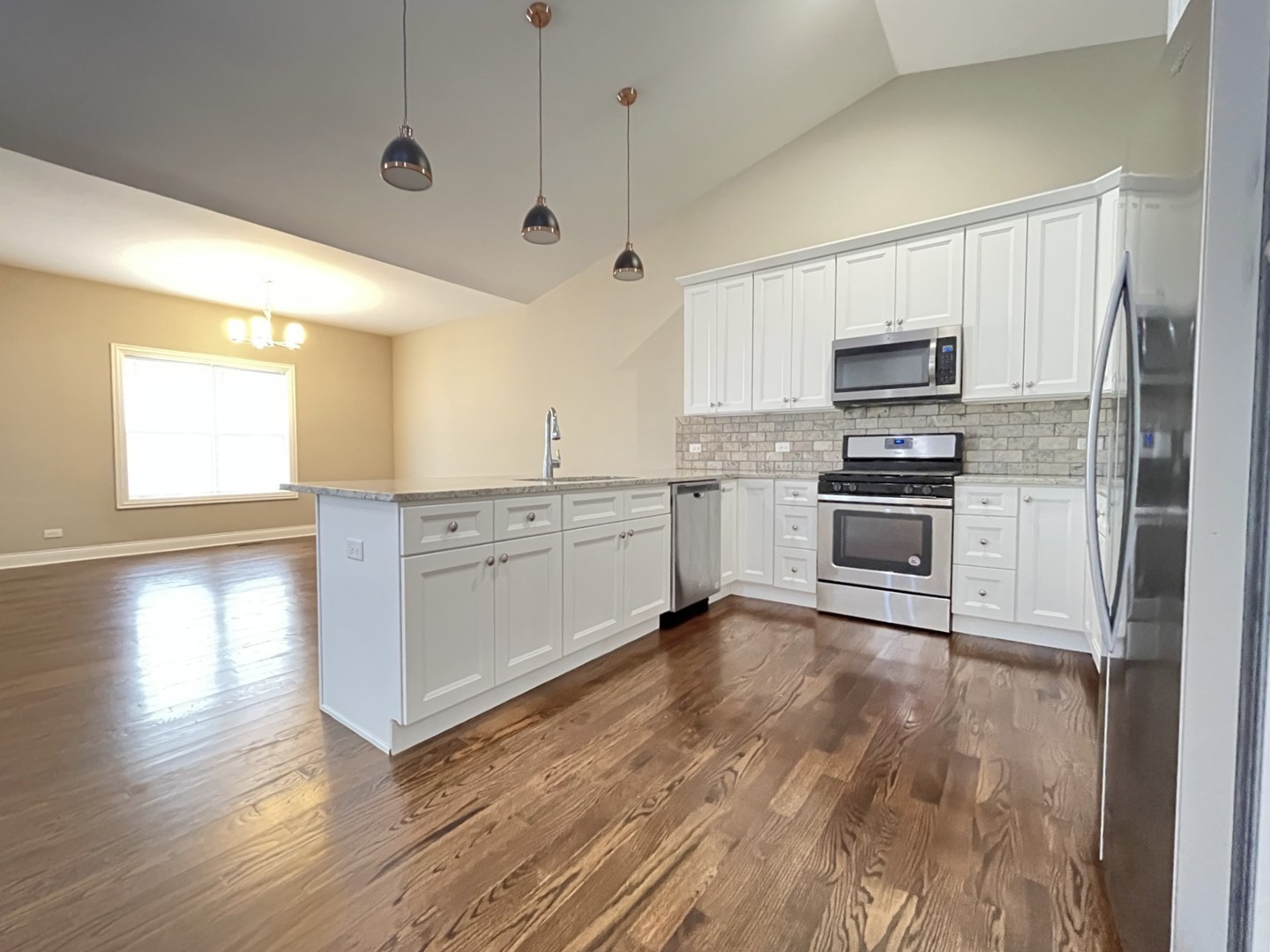 855 Meadow Lane Marengo, IL 60152 - Photo 4 of 22 a kitchen with stainless steel appliances a stove a sink and a refrigerator