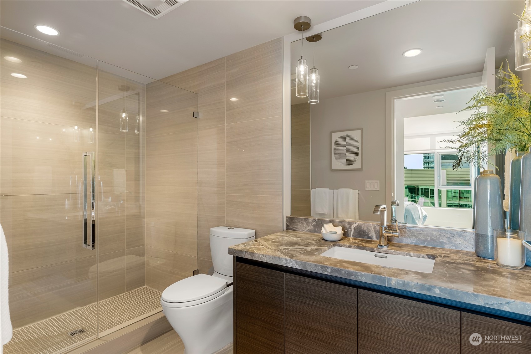 583 Battery Street, Unit 812N Seattle, WA 98121 - Photo 15 of 37 a bathroom with a granite countertop sink toilet and shower