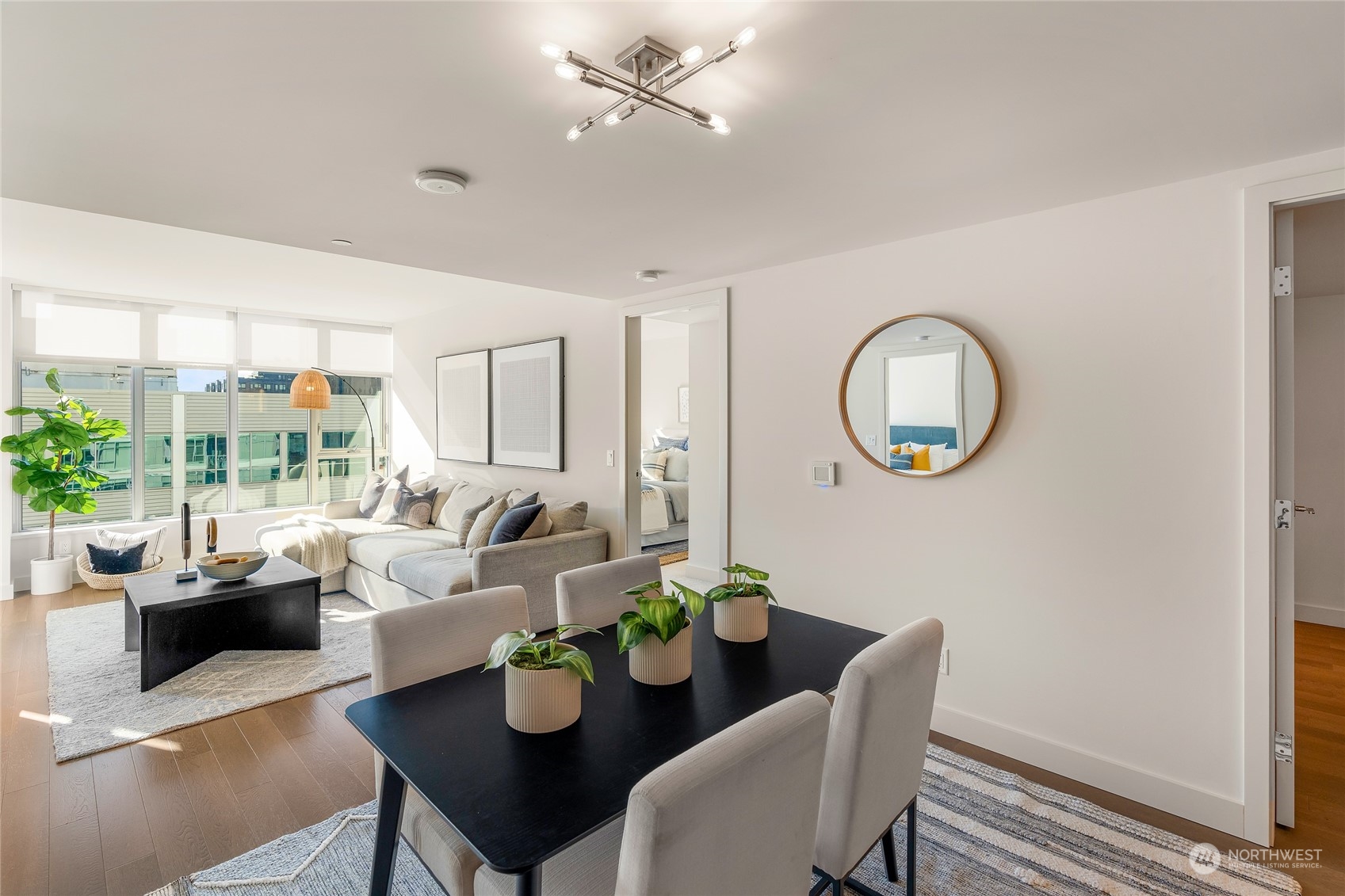 583 Battery Street, Unit 812N Seattle, WA 98121 - Photo 3 of 37 a living room with furniture chandelier and a mirror