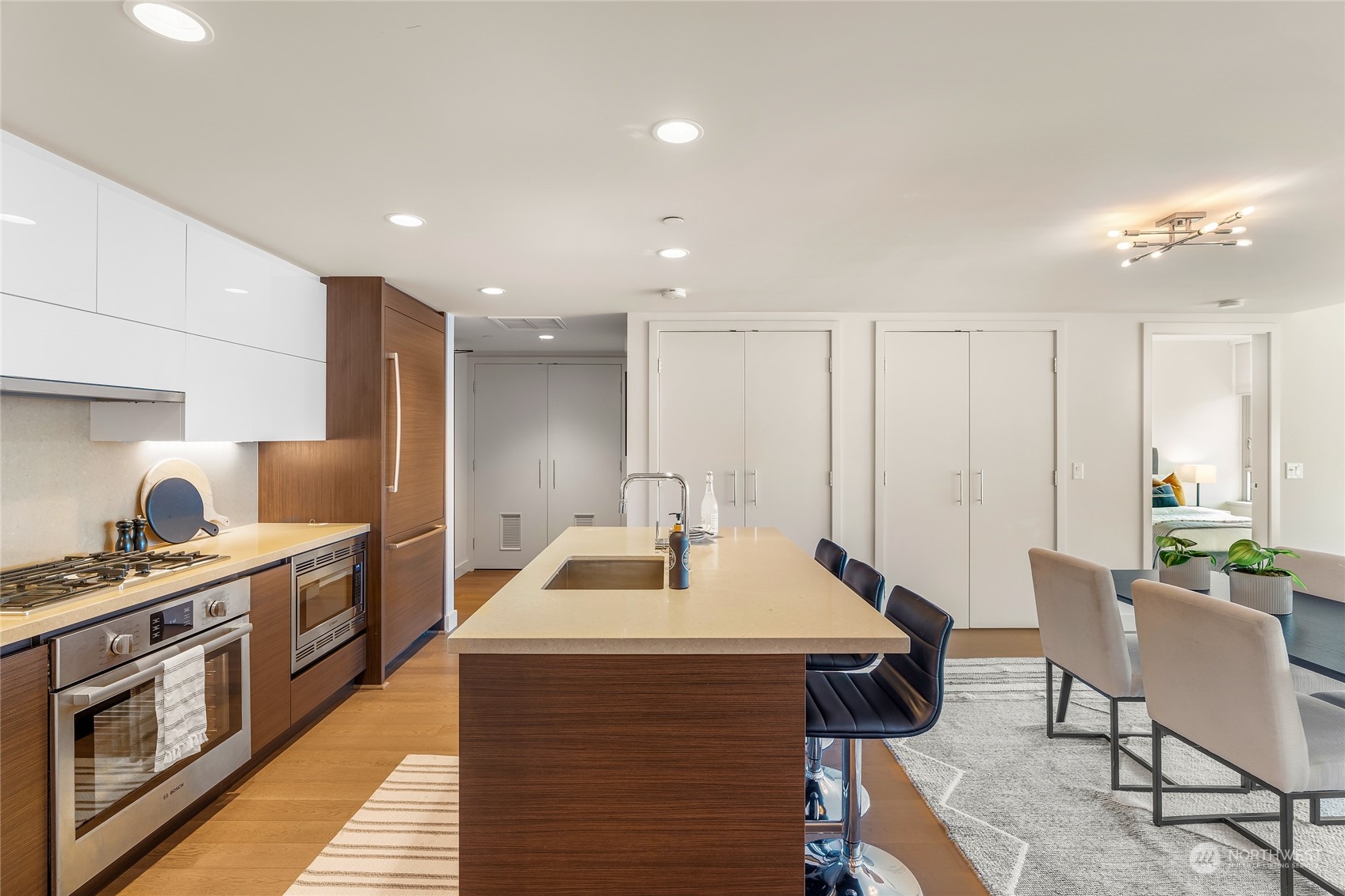 583 Battery Street, Unit 812N Seattle, WA 98121 - Photo 6 of 37 a kitchen with stainless steel appliances kitchen island granite countertop a sink and a stove