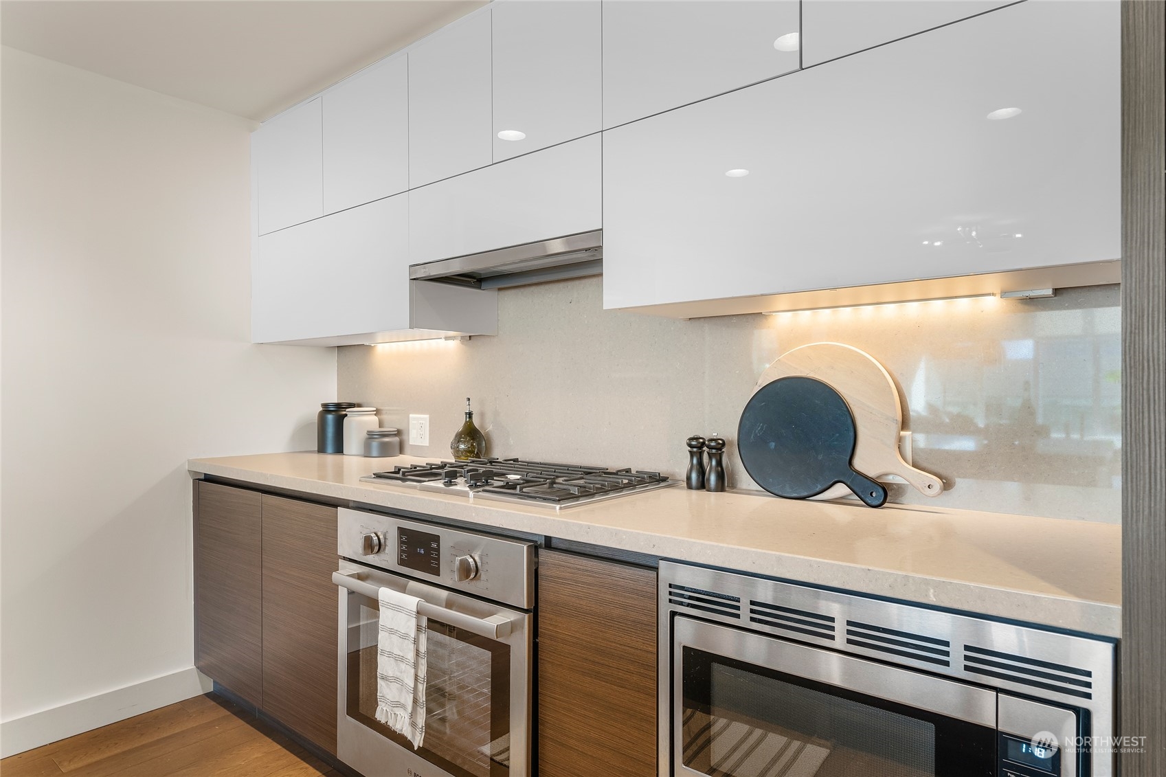 583 Battery Street, Unit 812N Seattle, WA 98121 - Photo 7 of 37 a kitchen with stainless steel appliances a sink and a stove