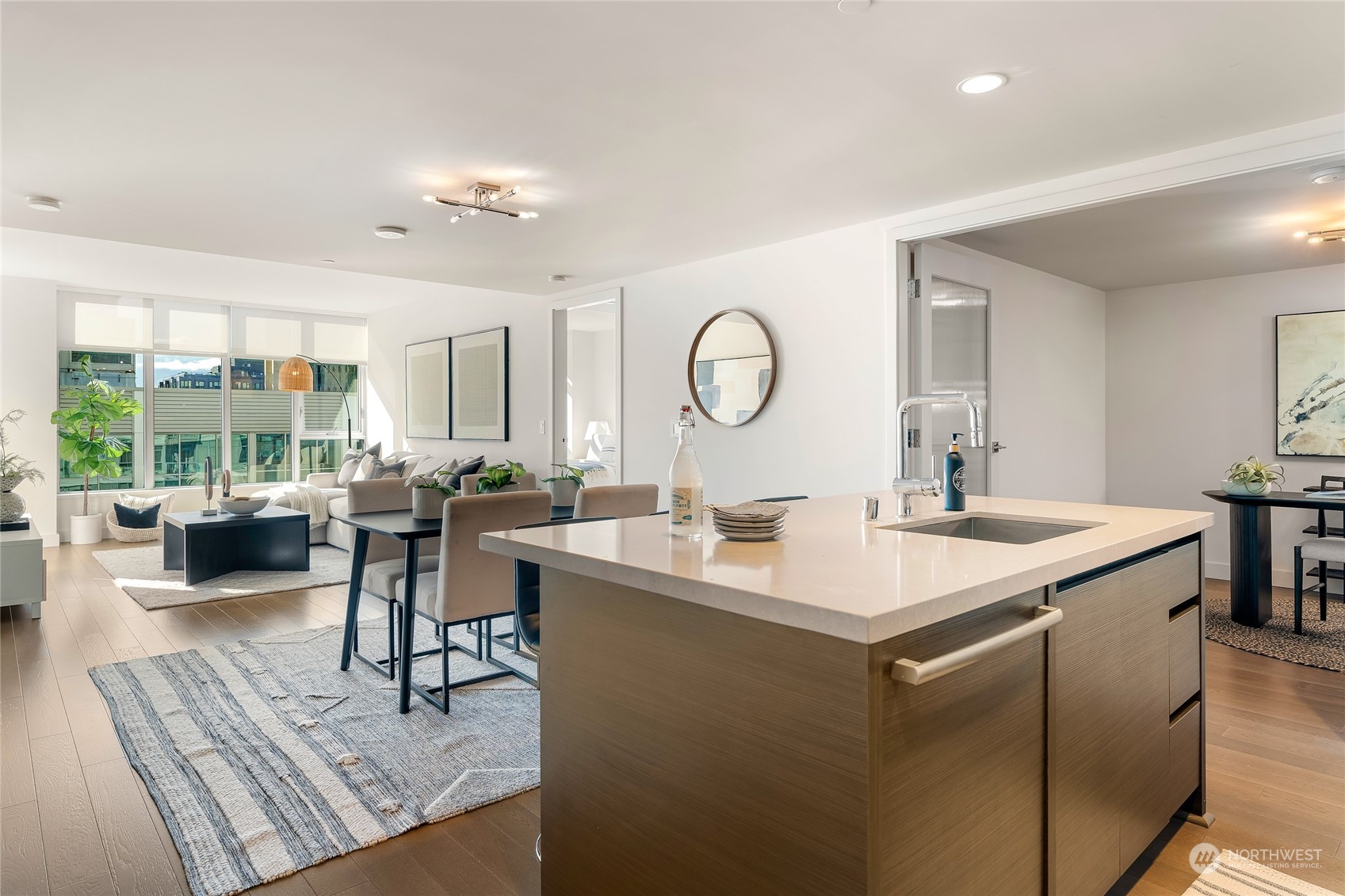583 Battery Street, Unit 812N Seattle, WA 98121 - Photo 8 of 37 a view of kitchen island a sink wooden floor and living room view