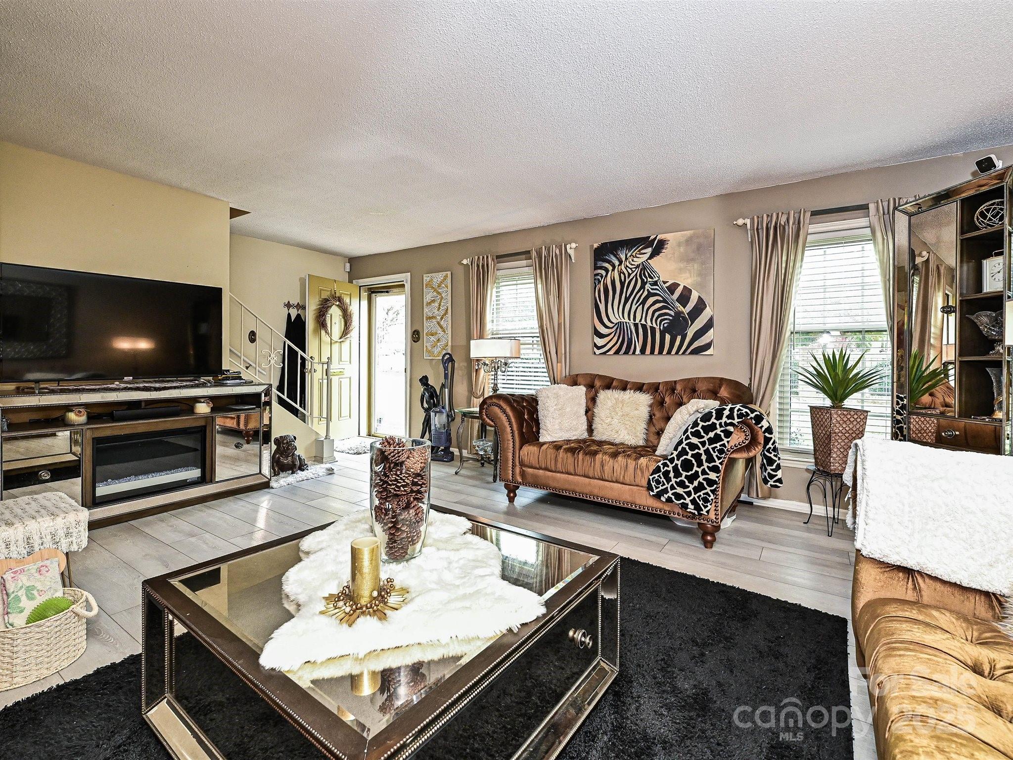 4520 Central Avenue, Unit H Charlotte, NC 28205 - Photo 13 of 28 a living room with furniture and a flat screen tv