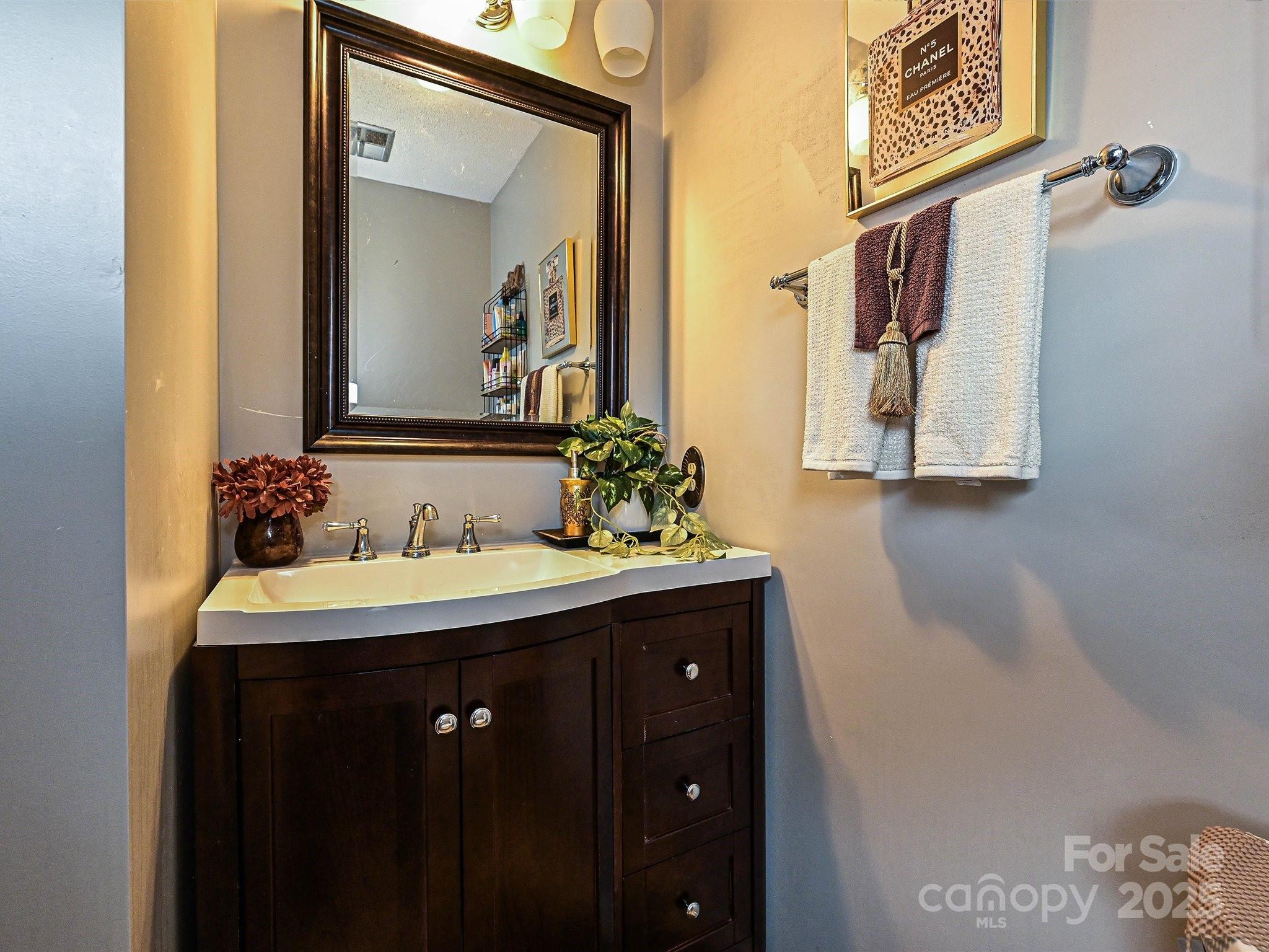 4520 Central Avenue, Unit H Charlotte, NC 28205 - Photo 20 of 28 a bathroom with a sink and a mirror