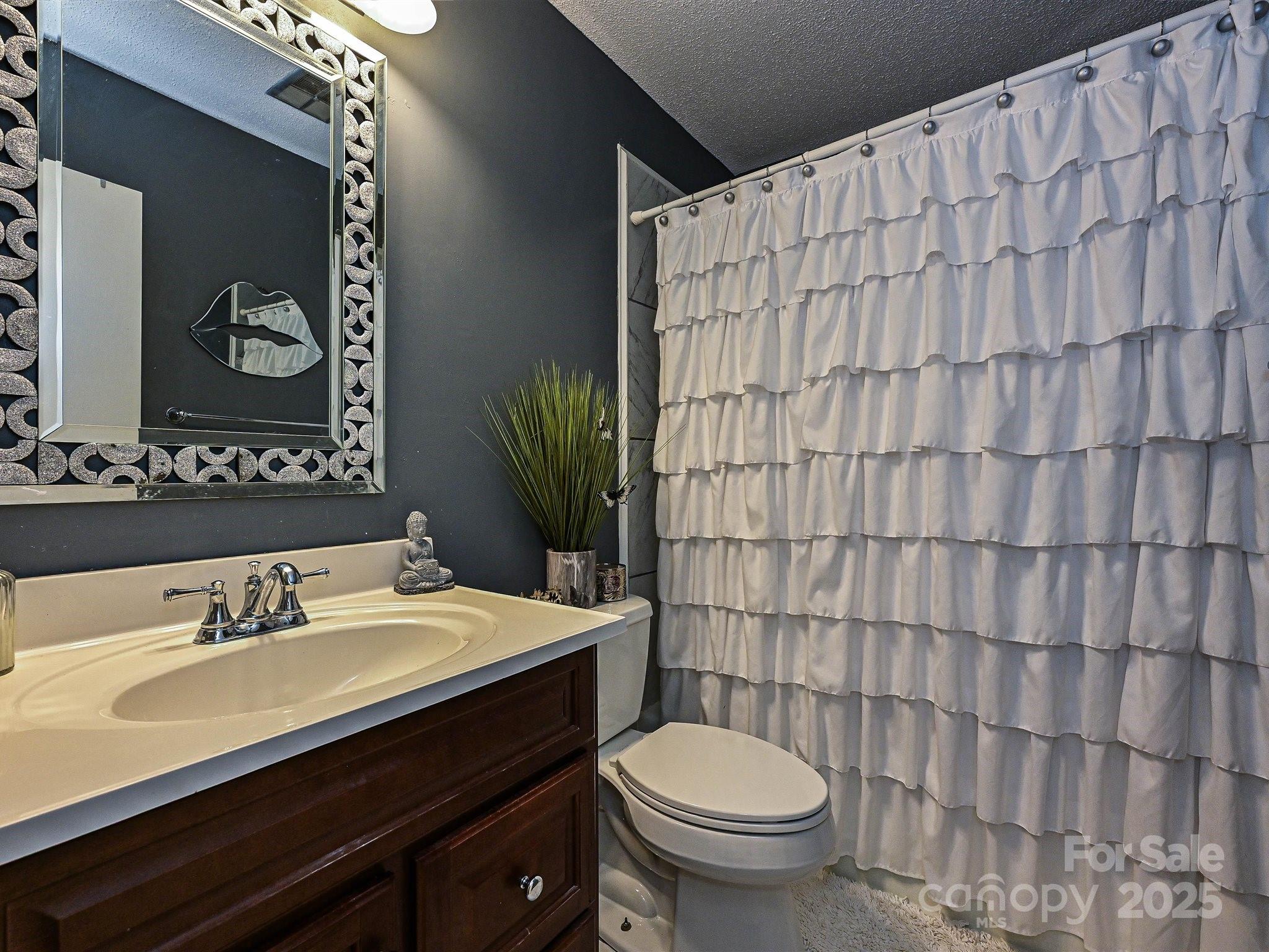 4520 Central Avenue, Unit H Charlotte, NC 28205 - Photo 22 of 28 a bathroom with a sink and a mirror