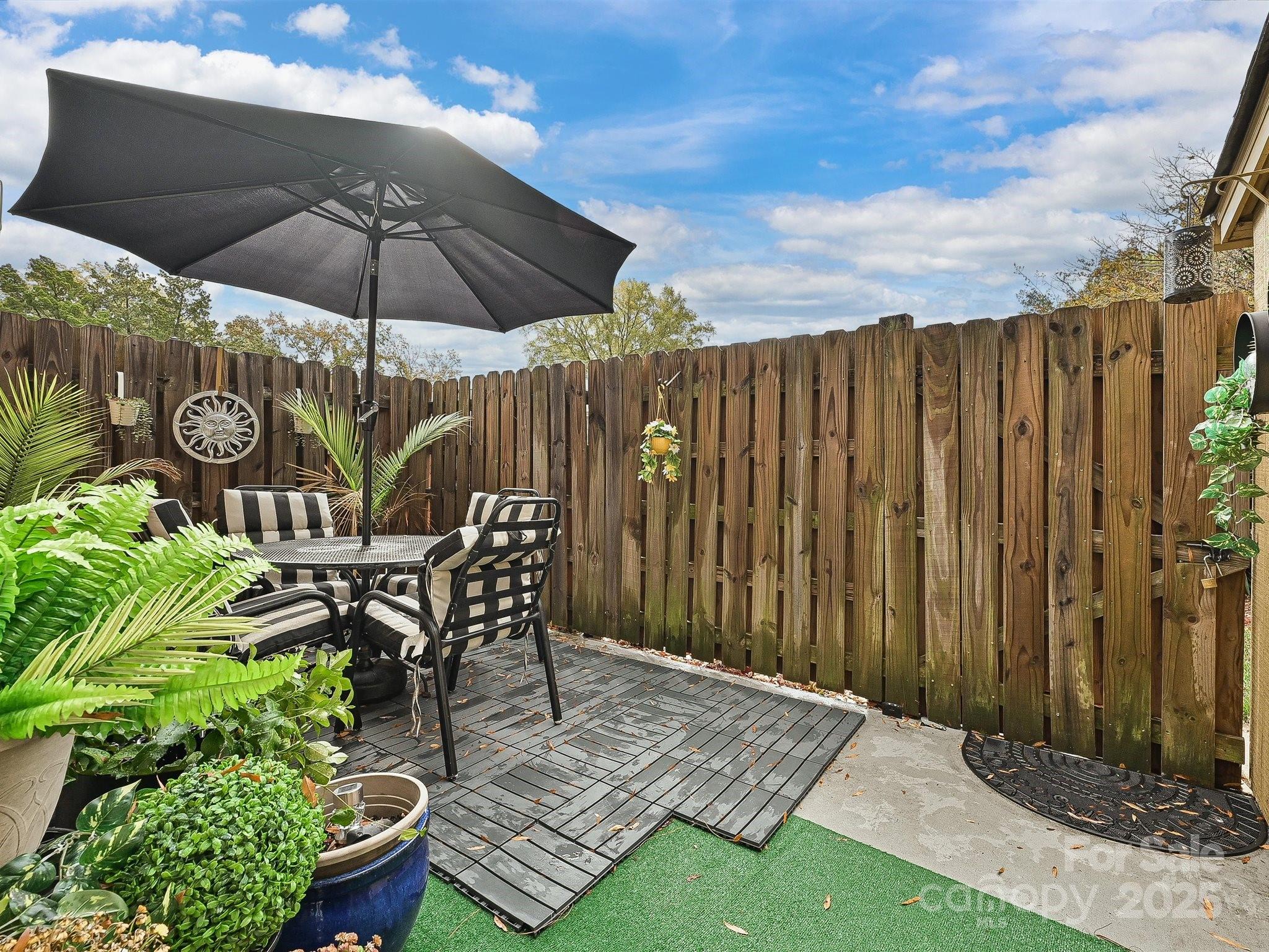 4520 Central Avenue, Unit H Charlotte, NC 28205 - Photo 24 of 28 a patio with a table and chairs