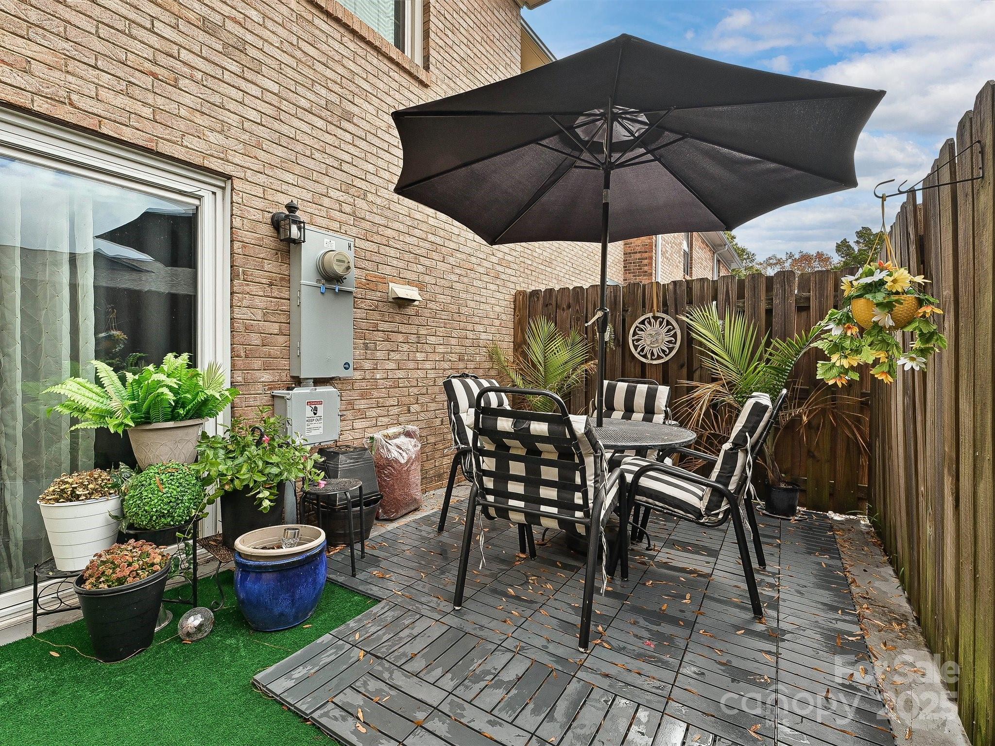 4520 Central Avenue, Unit H Charlotte, NC 28205 - Photo 25 of 28 a view of a patio with furniture and potted plants