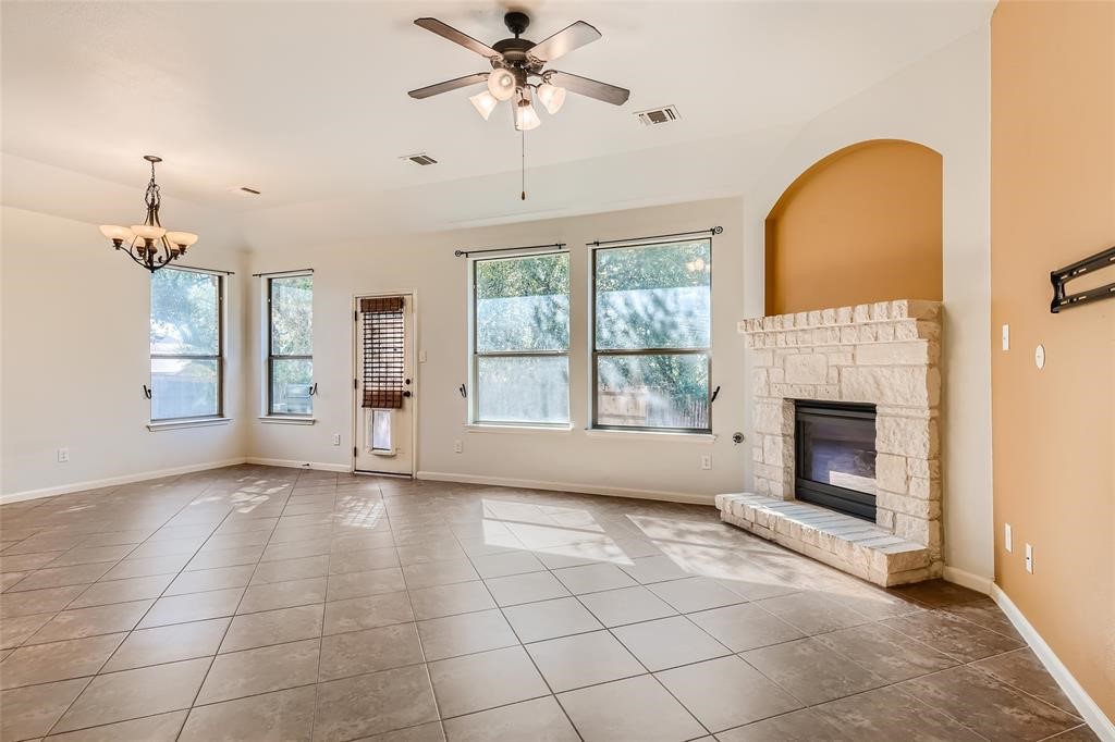 290 Maeves Way Austin, TX 78737 - Photo 4 of 13 A bright living space features a cozy fireplace and ample natural illumination.