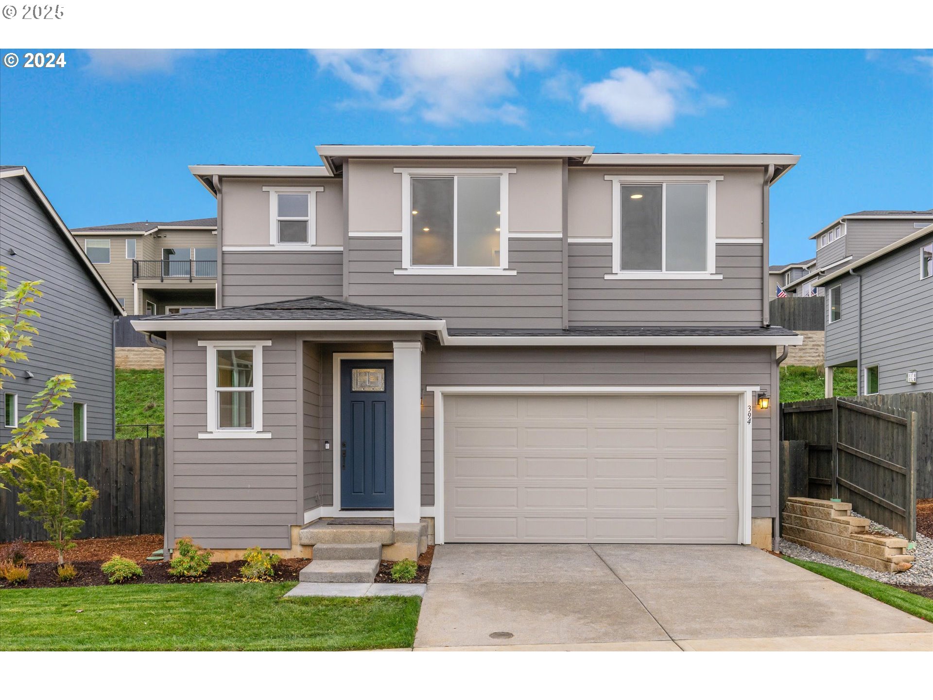 3865 West 4th Street Washougal, WA 98671 - Photo 1 of 24 a front view of a house with a yard and garage
