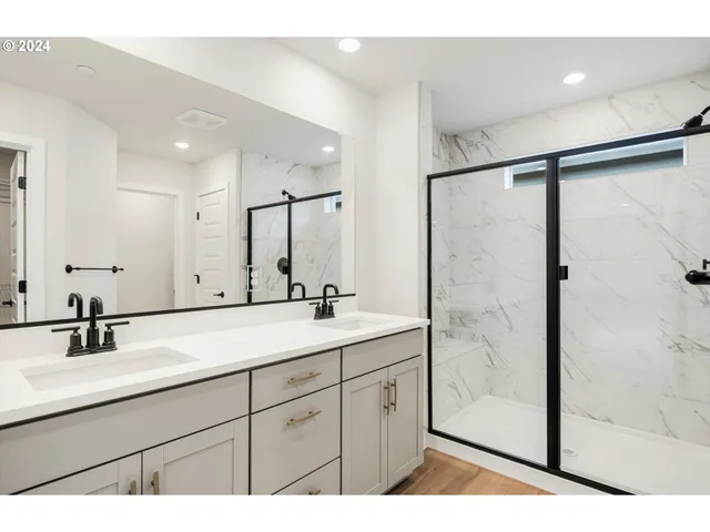 a bathroom with a shower and a glass door