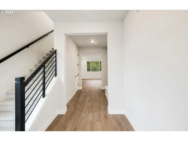 a kitchen with stainless steel appliances a stove a sink and white cabinets