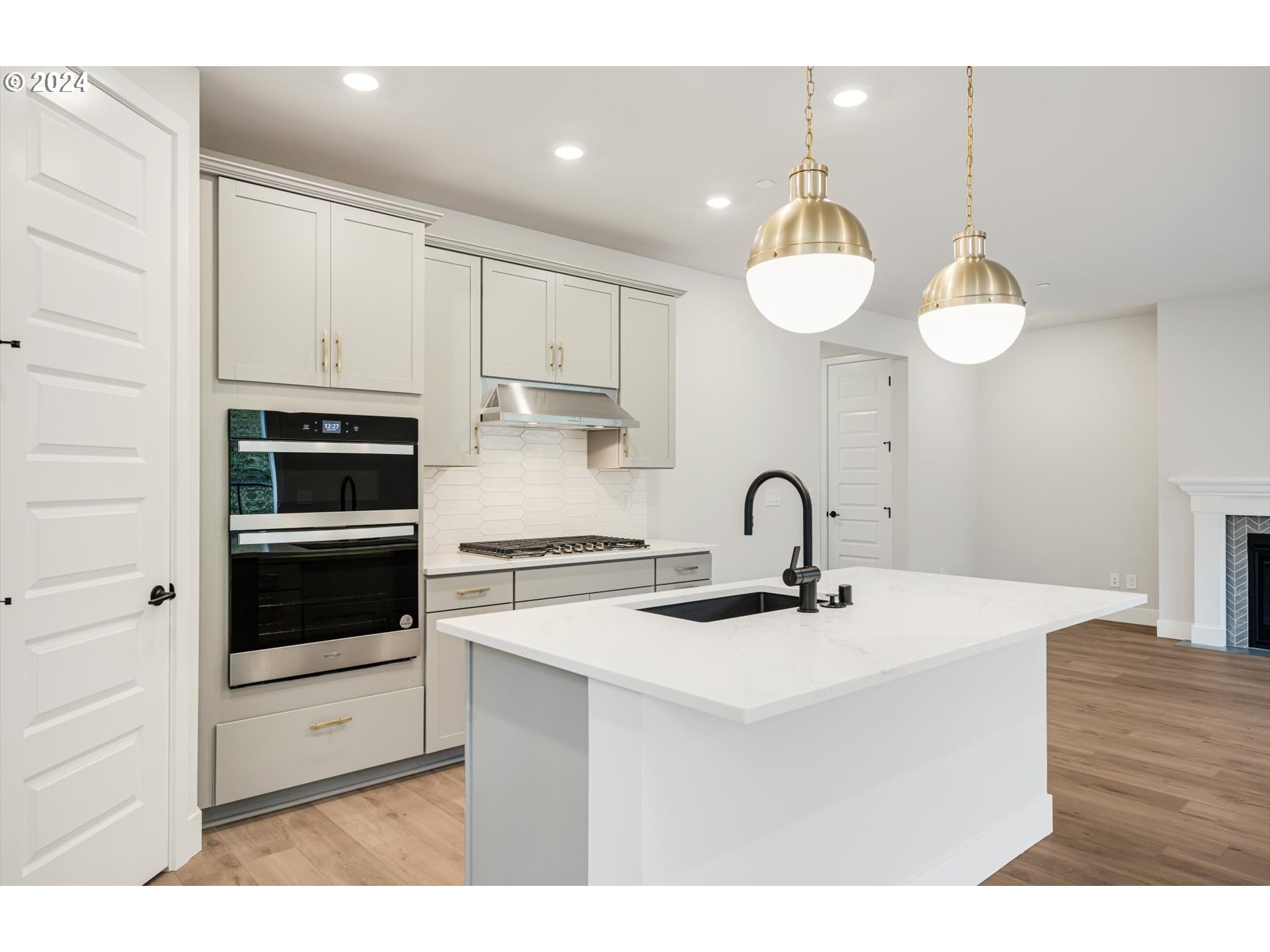 3865 West 4th Street Washougal, WA 98671 - Photo 7 of 24 a kitchen with stainless steel appliances a stove a sink and white cabinets