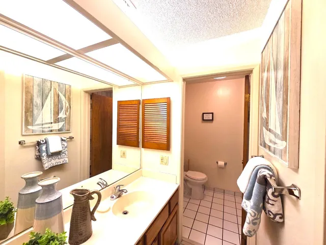 a bathroom with a sink mirror and a bathtub