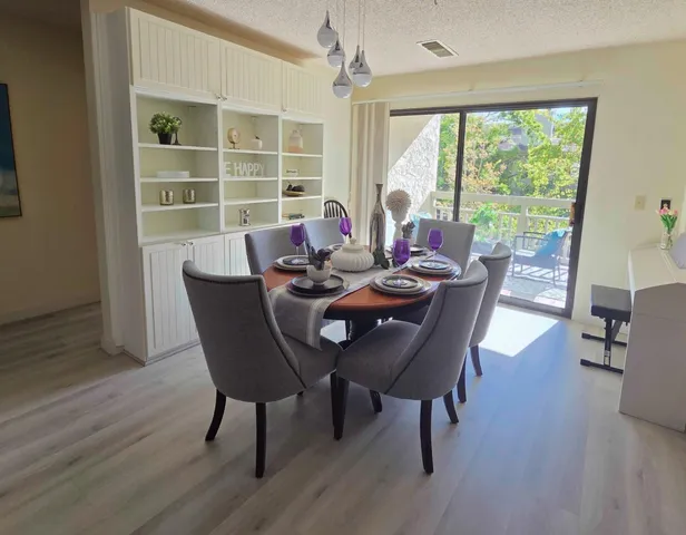 a view of a dining room with furniture window and wooden floor