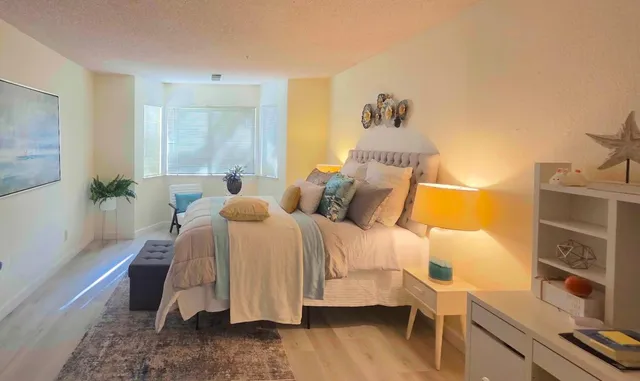 a bedroom with a bed and a lamp