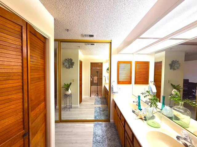 a spacious bathroom with a tub mirror and shower