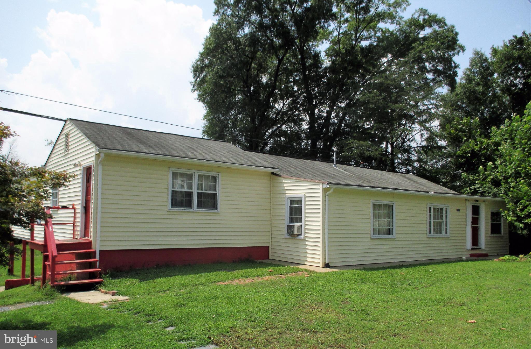 17762 Possum Point Road Dumfries, VA 22026 - Photo 1 of 13 a front view of house with yard and green space