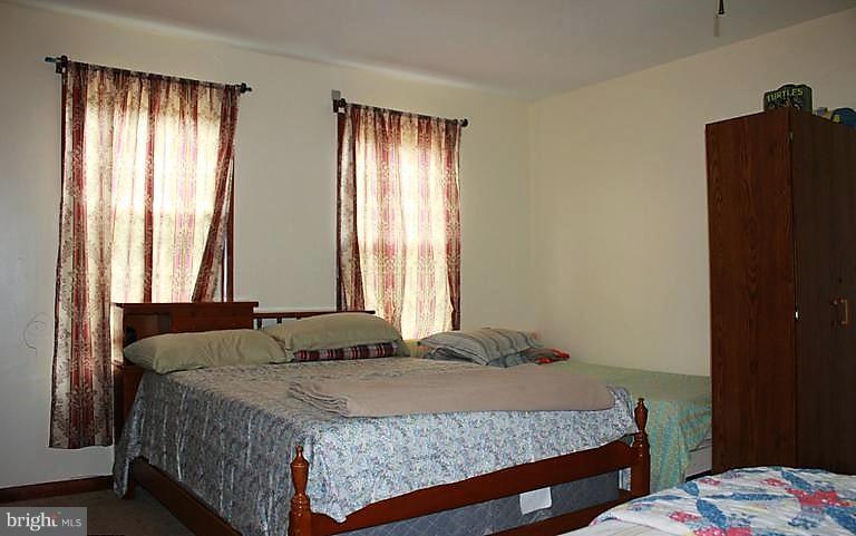 17762 Possum Point Road Dumfries, VA 22026 - Photo 9 of 13 a bedroom with a bed and a window