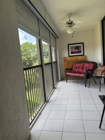 a view of a hallway with a couch and a window