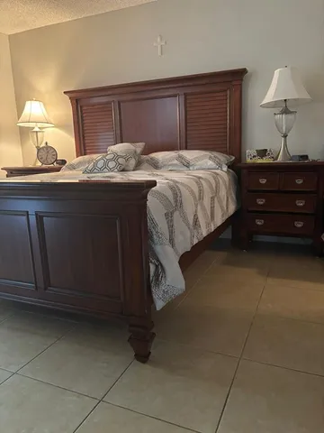 a bedroom with a bed and a lamp